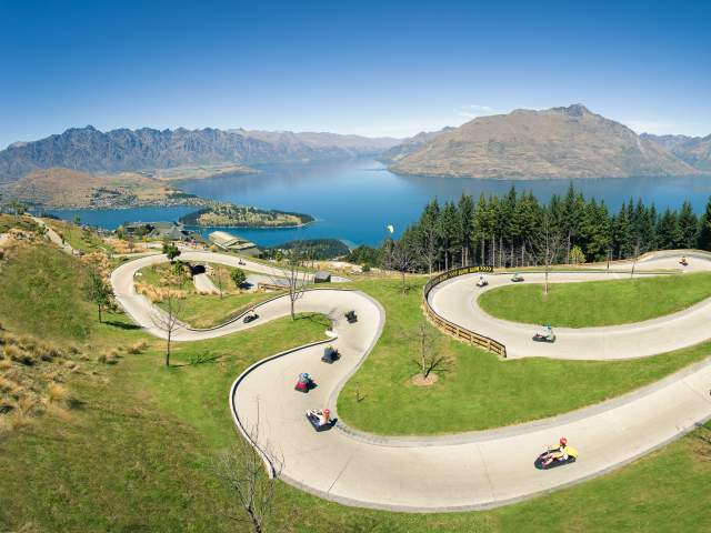 People on the Skyline Queenstown luge with elevated views of Queenstown