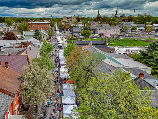 Picture of Lewisburg Arts Festival from an ariel perspective looking down market street above the vendor tents.