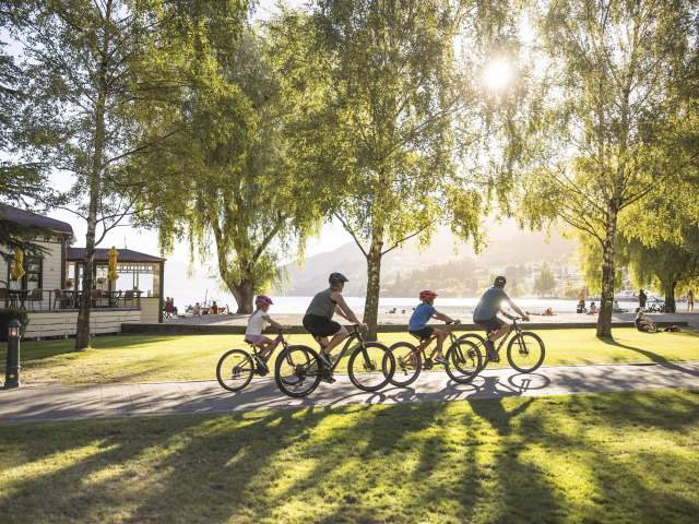 Family biking along Queenstown waterfront