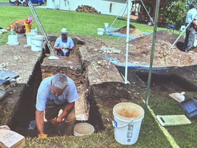 Volunteers digging at an archaeological site circa 2022.