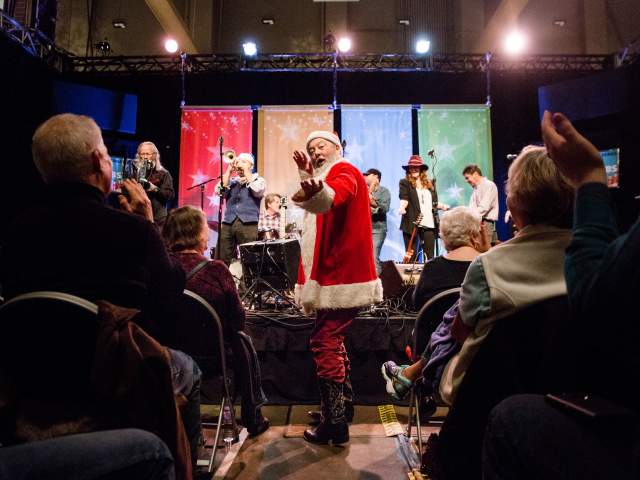 musician Shinyribs in Santa suit at Armadillo Christmas Bazaar in austin texas