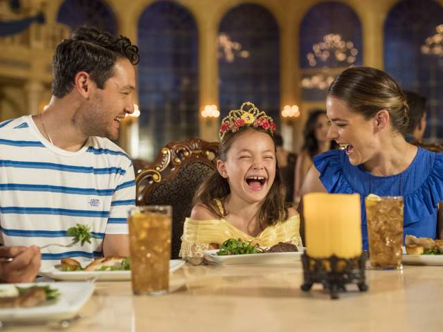 A family at a Be Our Guest dining experience in Magic Kingdom® Park
