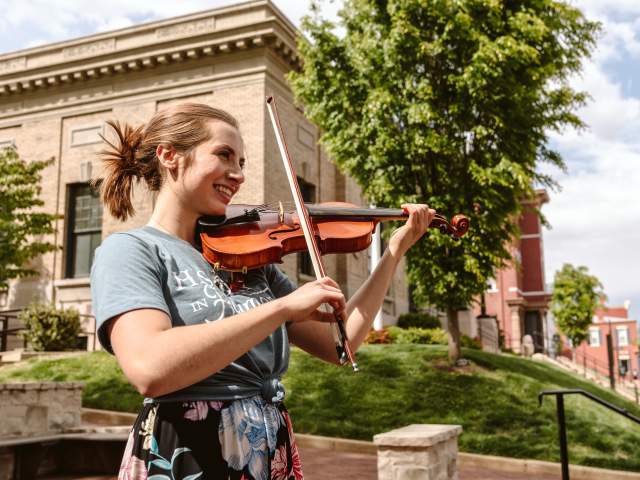 Woman Playing Violin Outside In St. Charles, MO