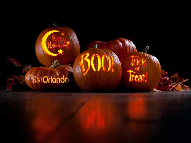 Pumpkins with Visit Orlando logo, Happy Halloween, Boo and Trick or Treat carved on them