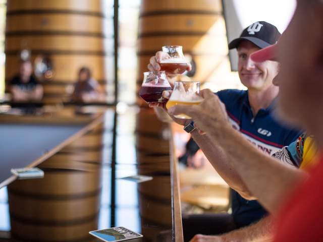 3 glasses of beer held up in the air at Upland Wood Shop