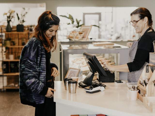 Person ordering coffee over the counter