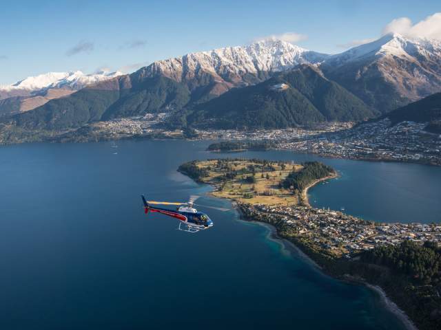 Helicopter flying over Queenstown Lake