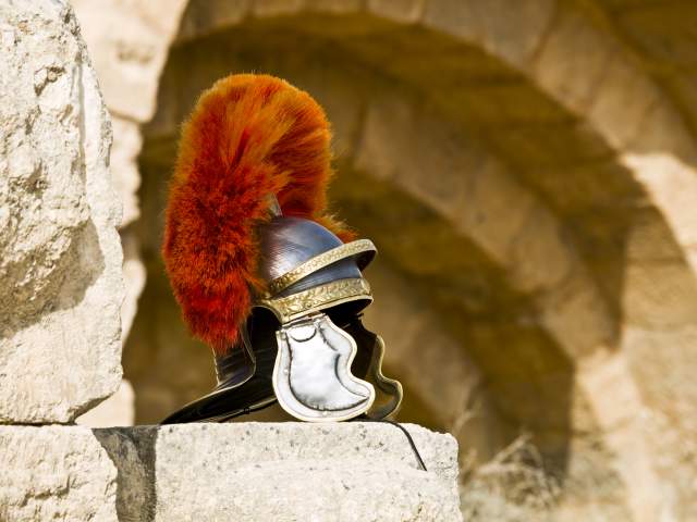 A centurion helmet displayed on roman ruins