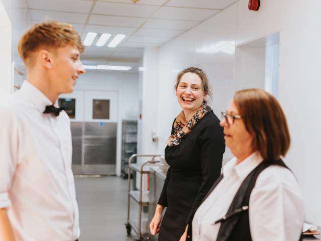 Smiling hotel staff at Petwood Hotel in kitchen