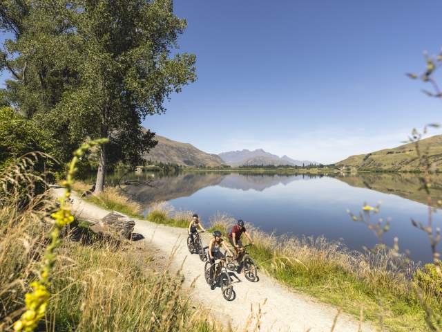 Group of friends biking around Lake Hayes