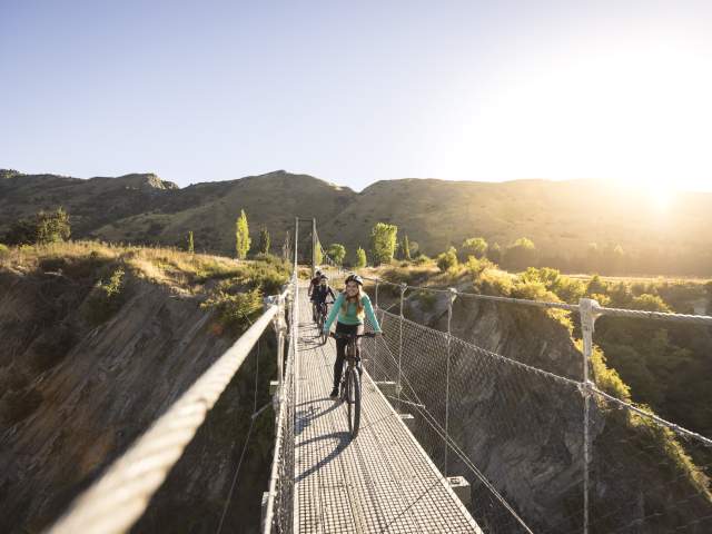 Biking across the Edgar Bridge on the Arrow River Bridges Trail