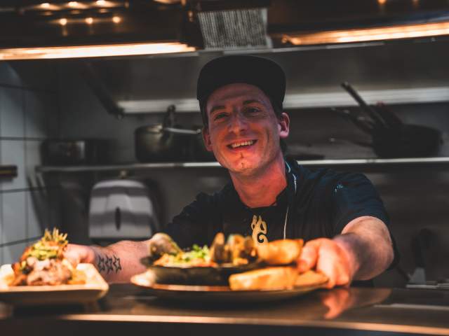 Owner Sam serving up with a smile
