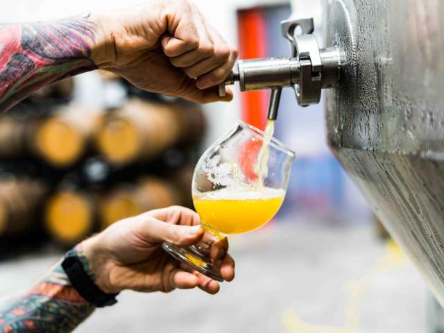 Man pouring a beer out of a tap