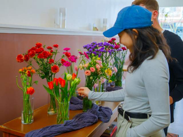 a couple looking at vases of flowers