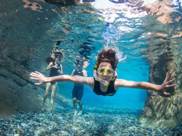 A woman snorkeling at Discovery Cove Wind-Away River