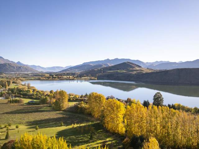 An aerial shot of Lake Hayes on an autumn day