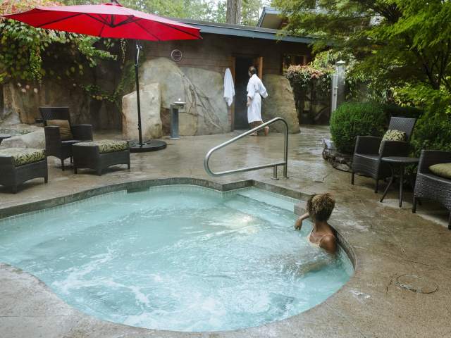 A woman sits in the hot tub at the spa.