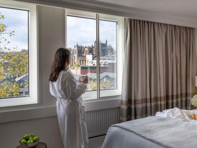 a view of a woman looking out the window of Bristol Cathedral and The Harbourside at The Bristol Hotel