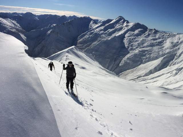 Snow shoeing on top of snow capped mountains