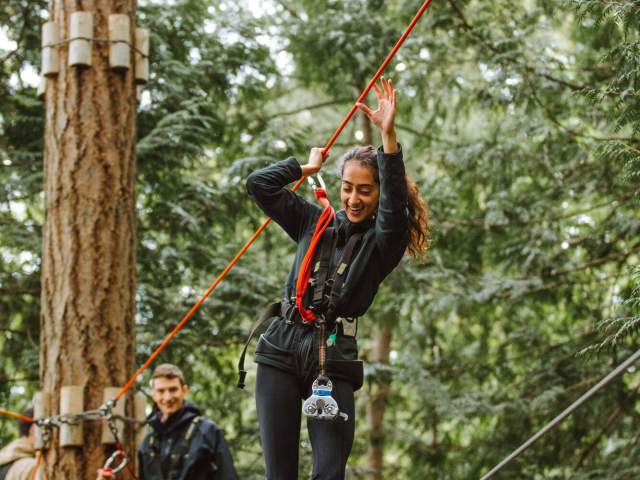 Two people on a tightrope at wildplay.