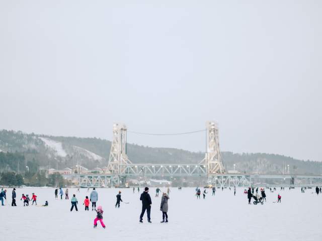 Ice skating in Houghton with Bridge in Background
