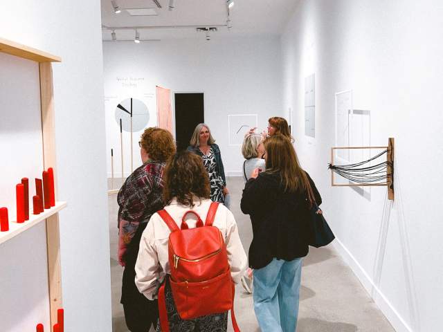 A group of people touring the art gallery.