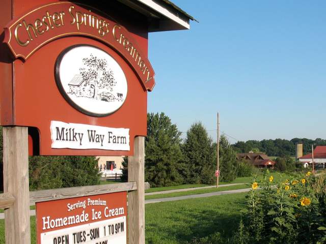 Exterior of a field on a farm with the signage Chester Springs Creamery, Milky Way Farm