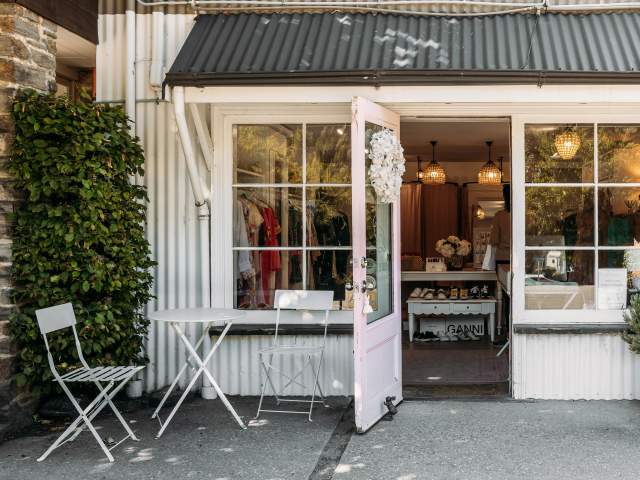 Outside view of a a white, cottage-style looking boutique shop