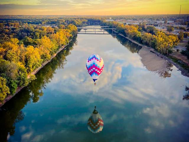 A hot air balloon hovering over the Wabash river in Terre Haute, Indiana