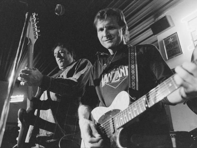 black and white photo of Butch Hancock and The Sunspots playing guitar at Burger Tex