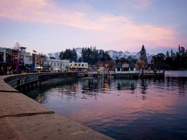 Queenstown waterfront in winter at sunset with the Remarkables mountain range covered in snow