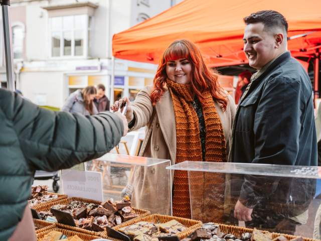Couple trying food at a street food festival