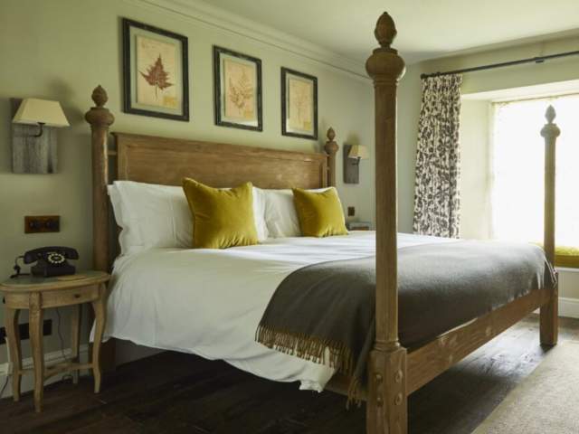 A bedroom with posts at The Pig Near Bath