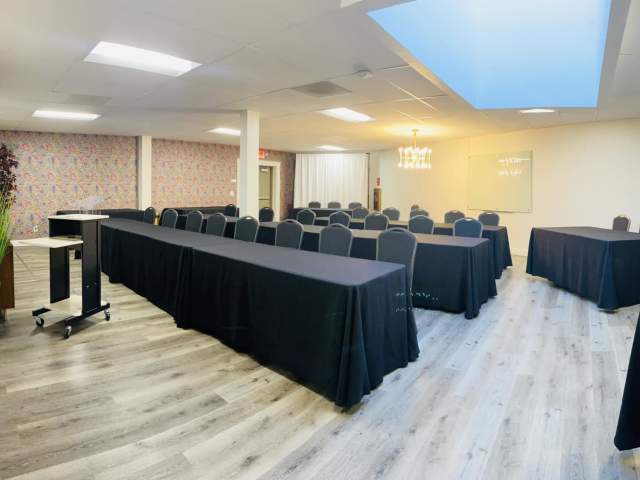 Lengthy black lined tables are set for a presentation viewing in the Executive Conference Room