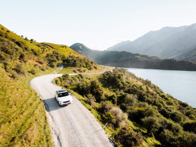 EV driving to Moke Lake with mountains in the background