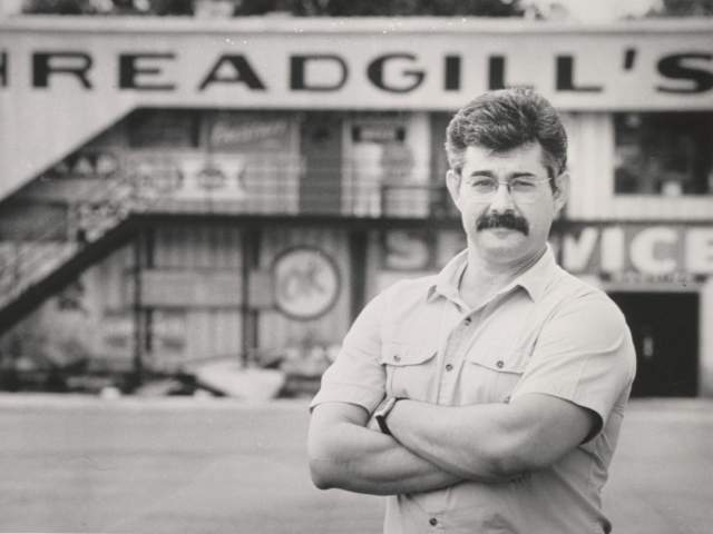 Photo of Eddie Wilson standing in front of his restaurant and music venue Threadgills in Austin Texas