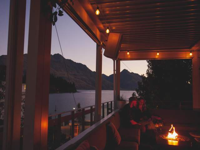 People enjoying a drink at sundeck roof top bar