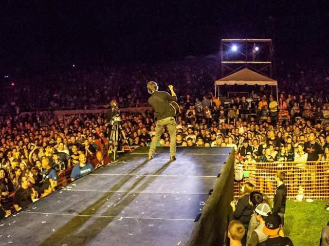Crowd surrounding the stage at night during the Uprise Festival