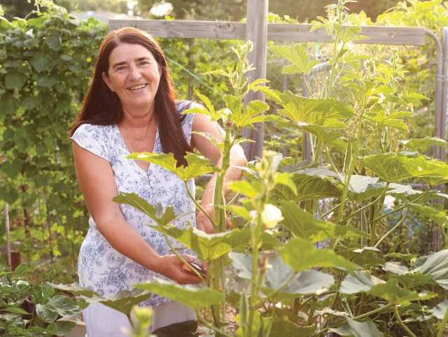 woman kneeling in a veggie garden