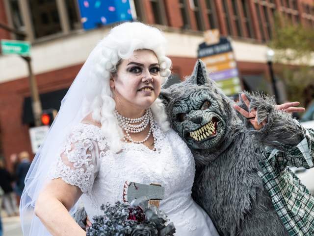 couple in halloween costumes as a zombie bride and warewolf