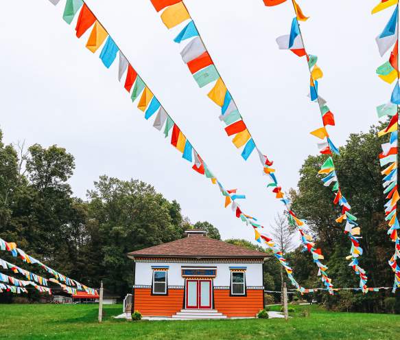 Prayer flags and a building at the Tibetan Mongolian Buddhist Cultural Center