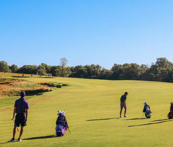 Three men playing golf at The Pfau Course at Indiana University