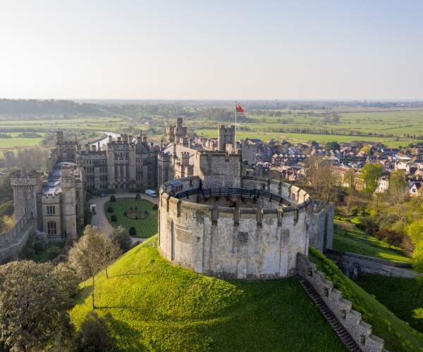 Aerial view of the keep at Arundel Castle with Arundel and fields in the distance