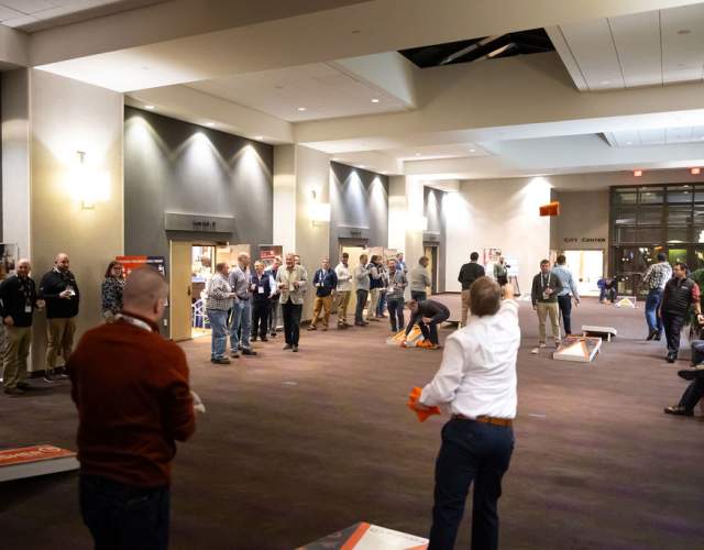 people playing cornhole at conference