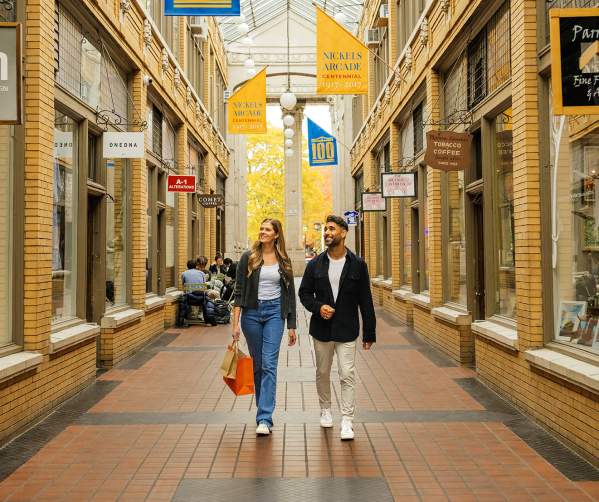 Young couple walking through covered outdoor walkway
