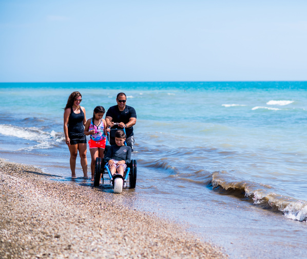 family of 4, son in wheelchair on Bradford Beach