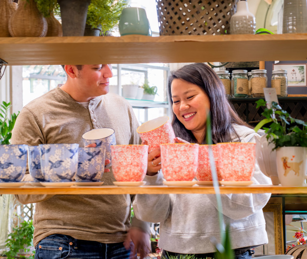 couple looking at colorful plant pots