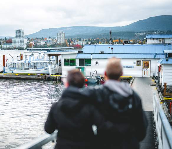 Two people looking over the Nanaimo harbour.