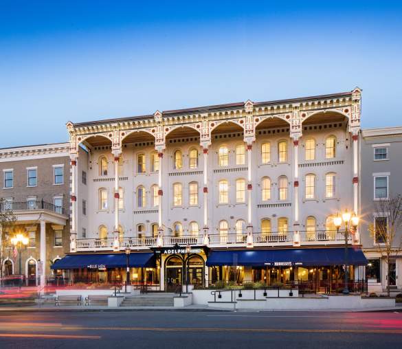 Adelphi Hotel at dusk with lights on