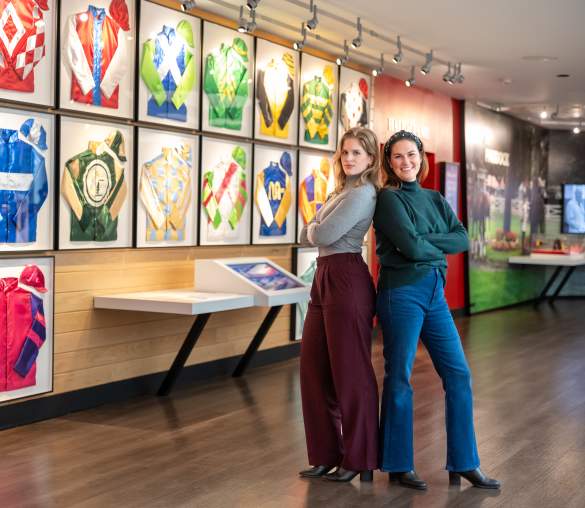 two women standing back to back